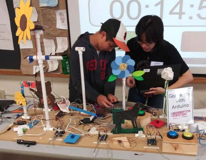 Middle school students amid projects in the Arduino garden activity
