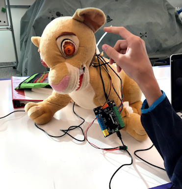 a Simba plush toy modified with electronics
