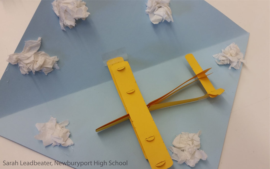 a pop-up card showing a cut-paper biplane and clouds made of crumpled tissue paper