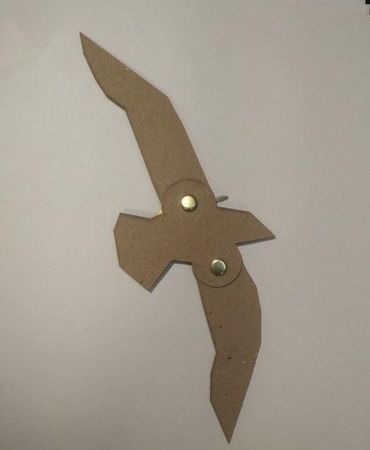 a laser-cut bird puppet with brass brads forming moveable joints
