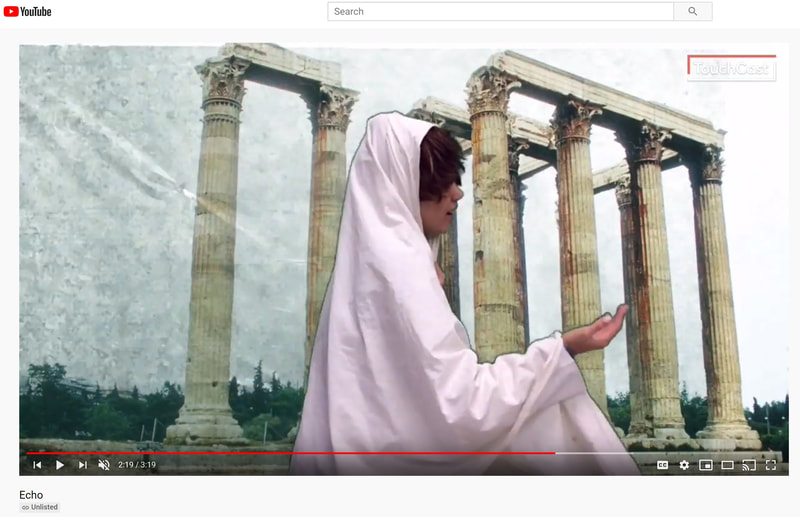 screenshot of a student costumed in a robe against a greenscreened backdrop of Greek-style columns