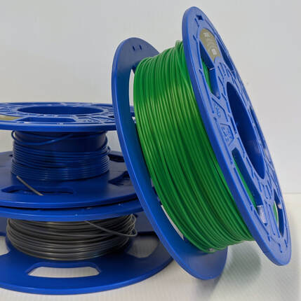 three spools of PLA filament
