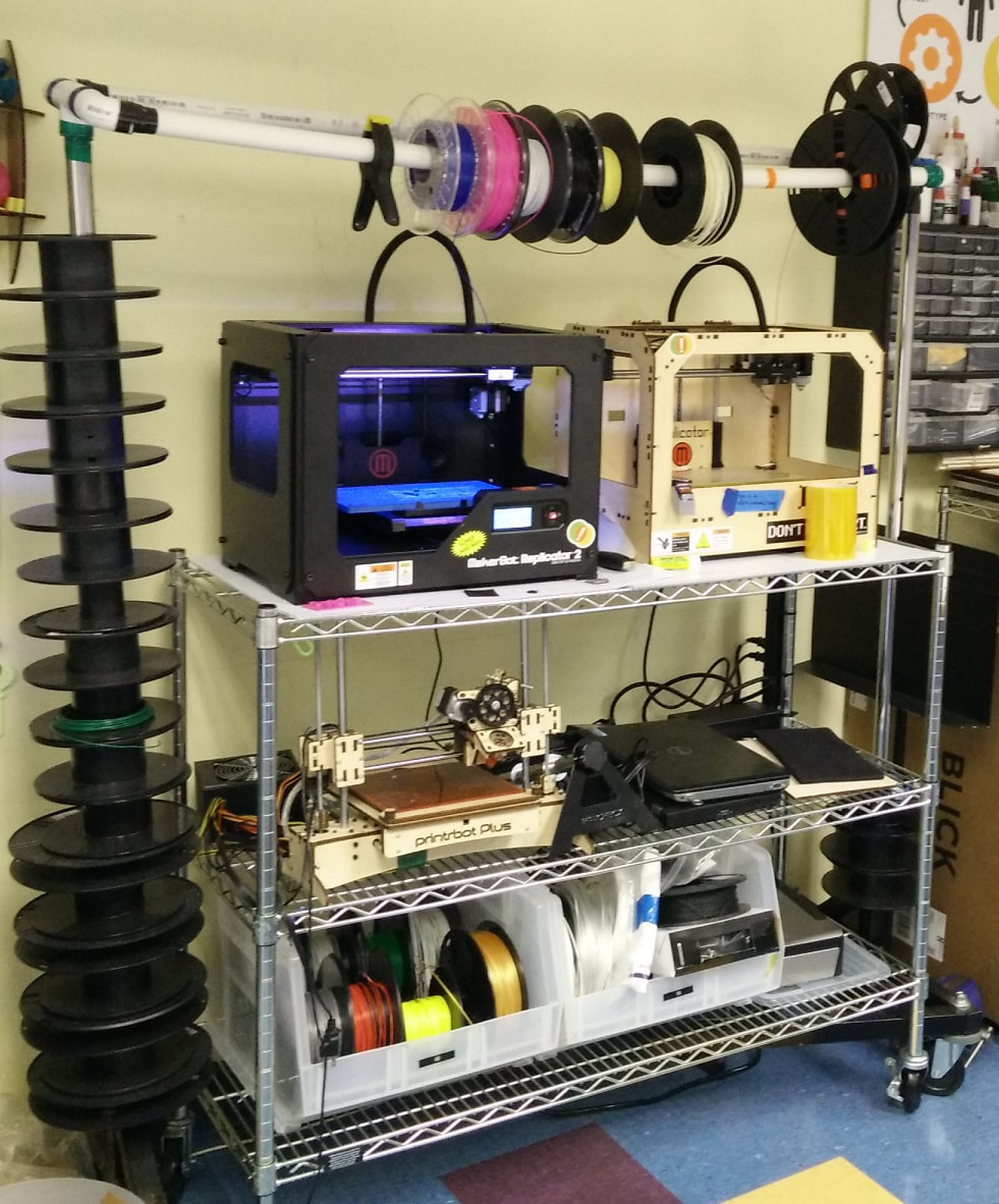 Photo of a portable cart of 3D printers and supplies for them