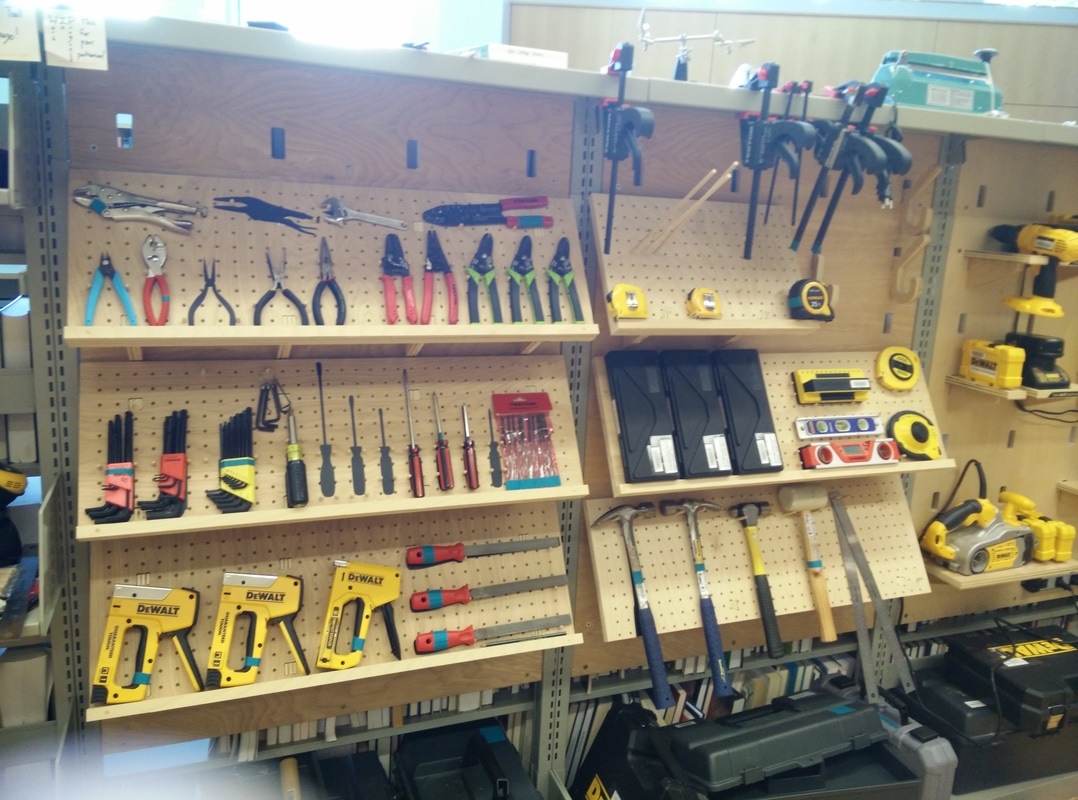 Photo of well-organized tools on a peg-board wall