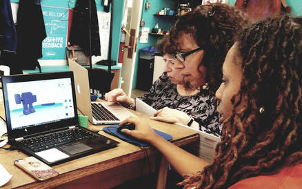 Women learning 3d printing software on a laptop