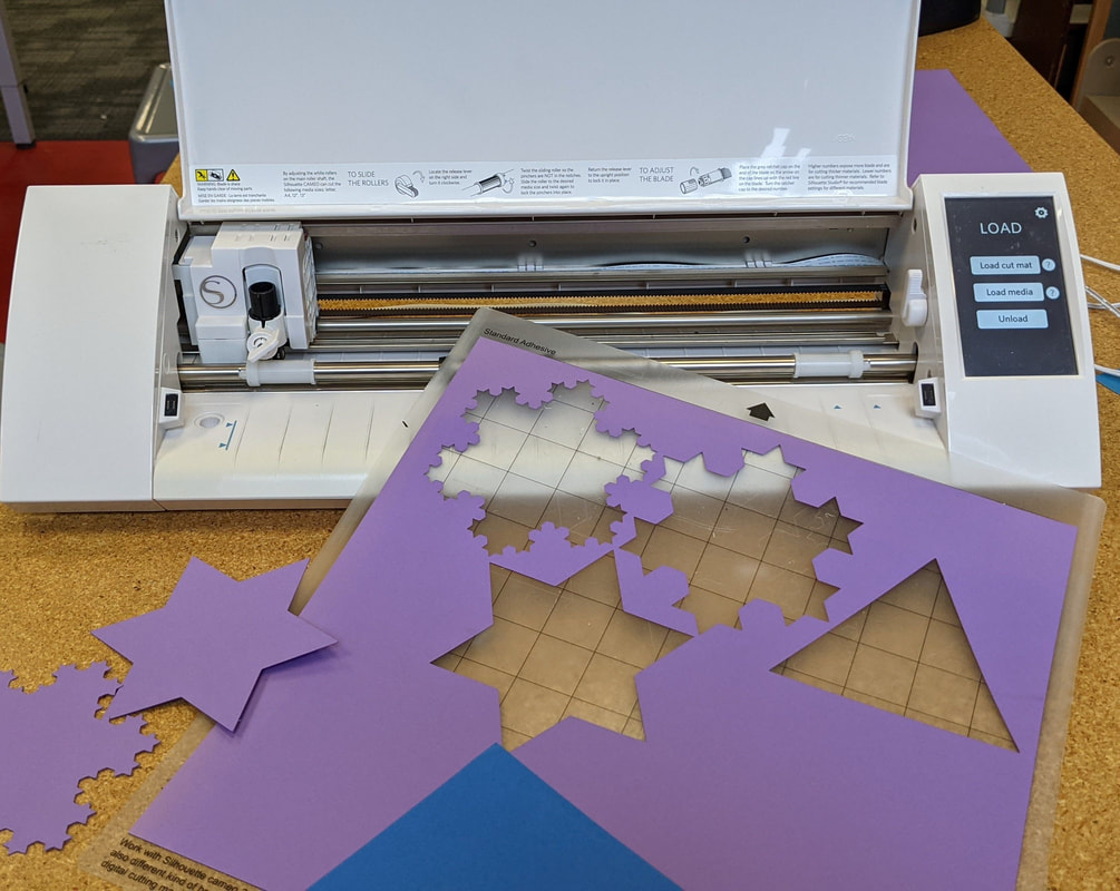 photo of the silhouette craft cutter machine with snowflake cutouts