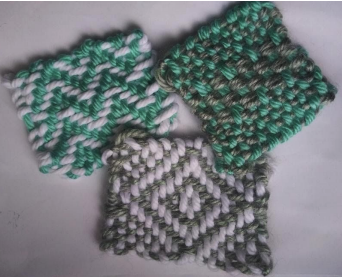 3 woven yarn squares, each with distinctive 2-color patterns